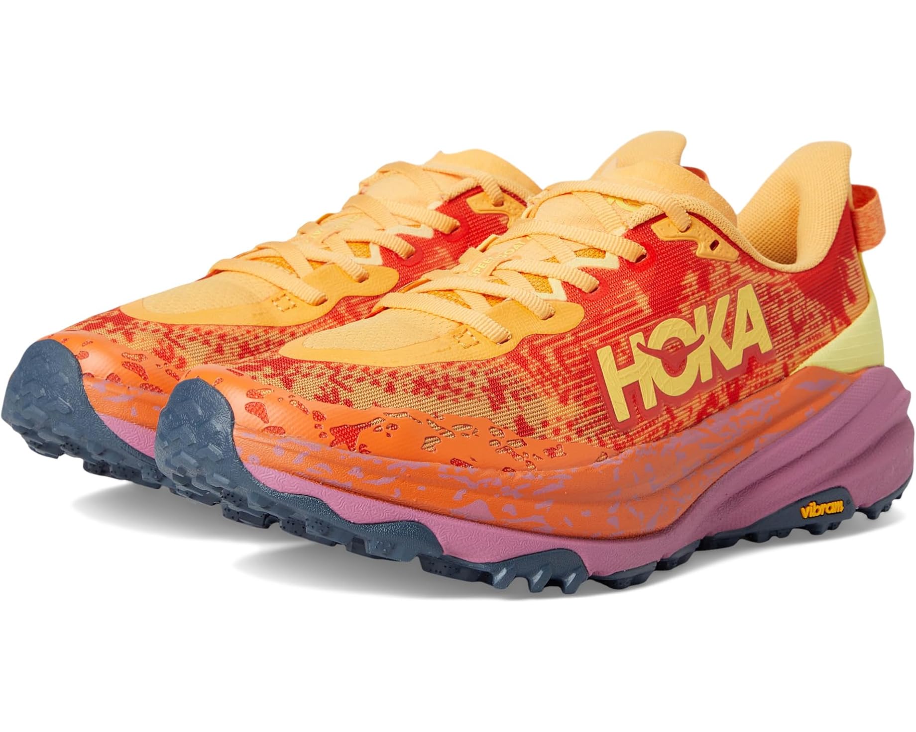 Hoka Speedgoat 6 trail running shoe on dirt path, showing Vibram Megagrip outsole and breathable mesh upper.