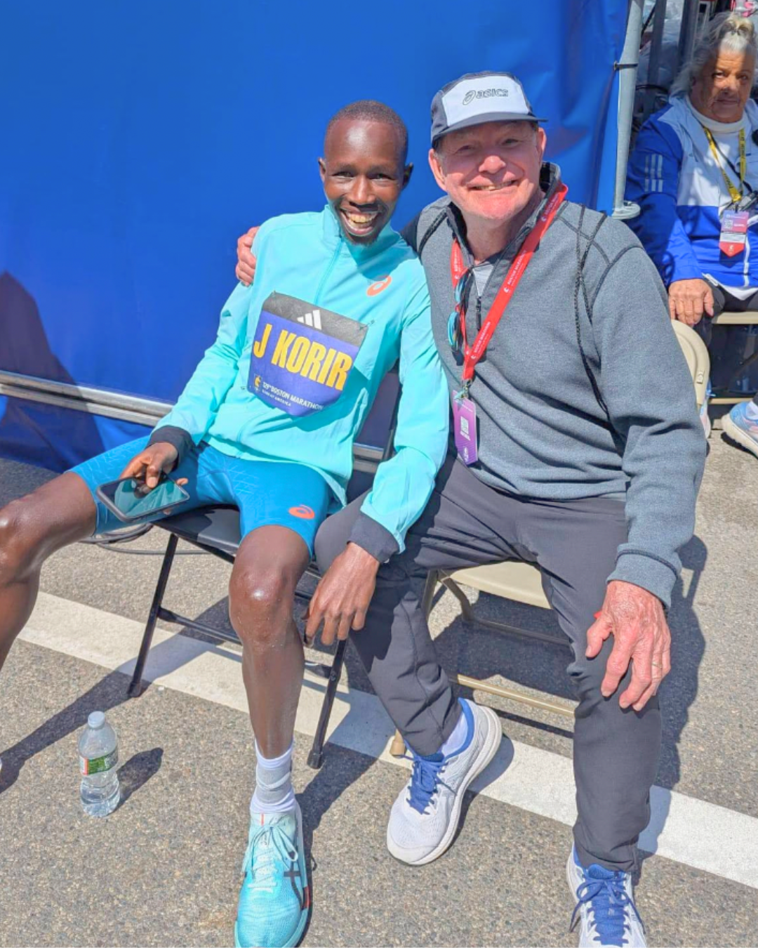 John Korir, wearing his Kenya singlet and gold medal, stands with his coach Ron Mann After boston marathon