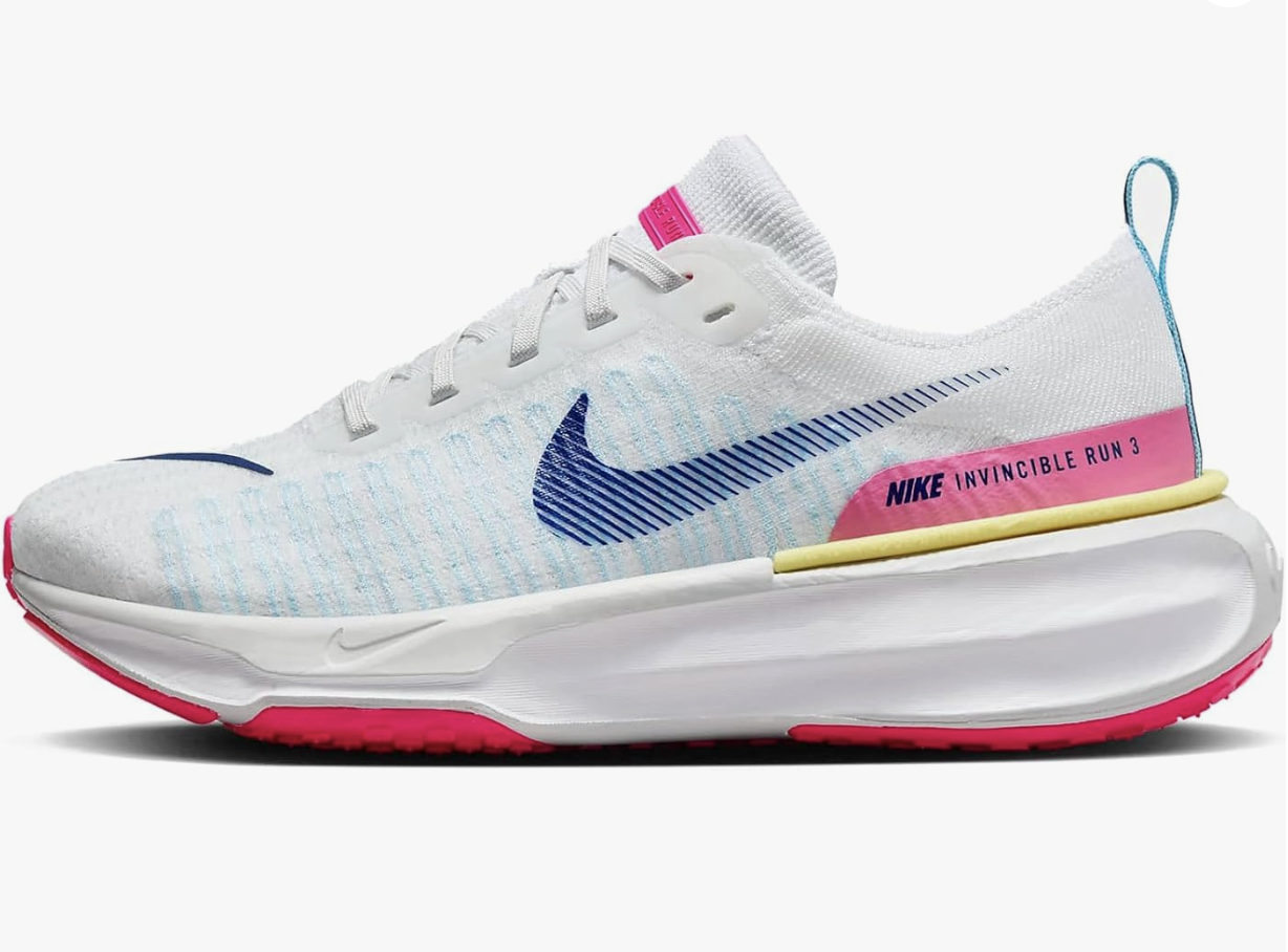 Nike Invincible 3 running shoe in bright mango and hyper pink colorway on pavement during outdoor wear test.