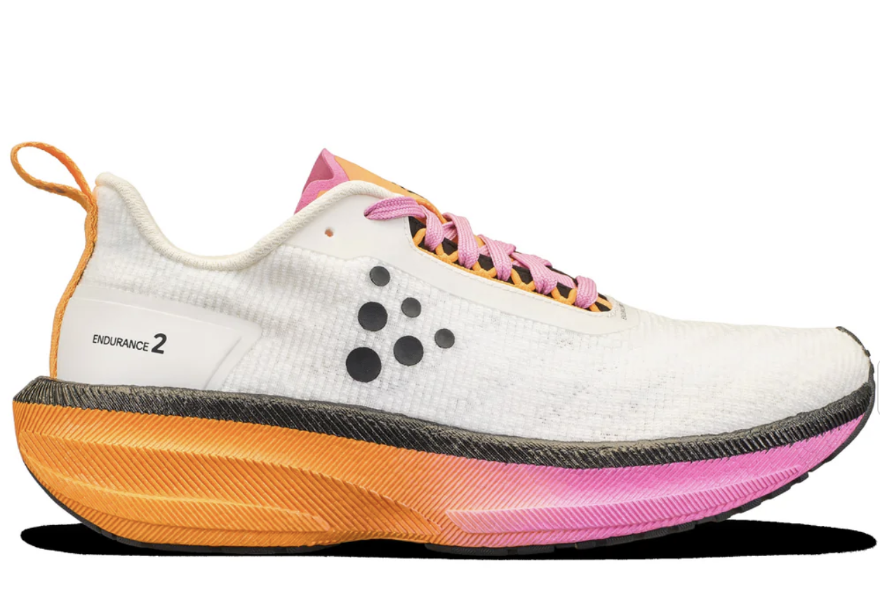 Craft Endurance 2 running shoe in Ash White and Fuchsia colorway displayed outdoors for a tempo-run focused review.